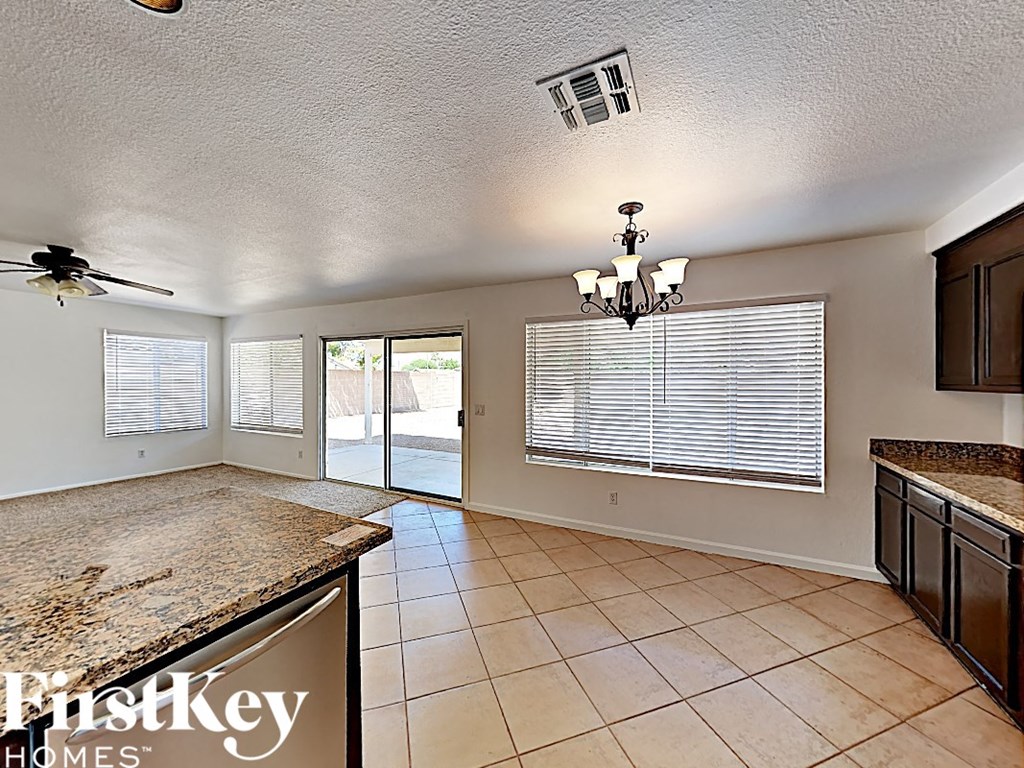 a kitchen with a large window and a door to a patio