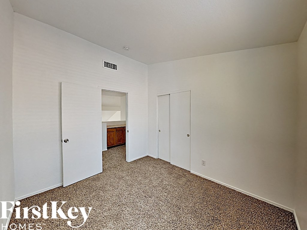 a bedroom with two closets and a door to a bathroom