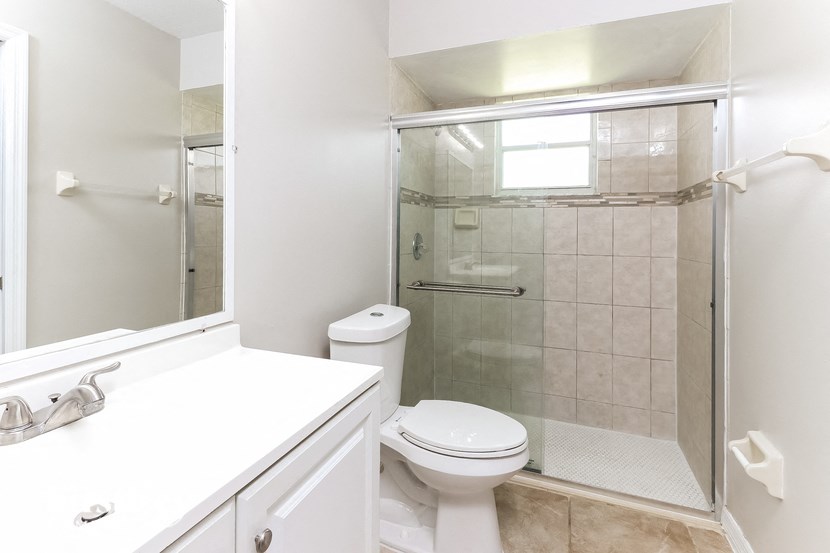 a bathroom with a toilet and a shower