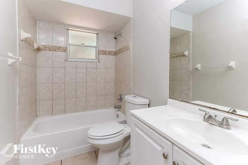 a bathroom with a sink toilet and a bath tub