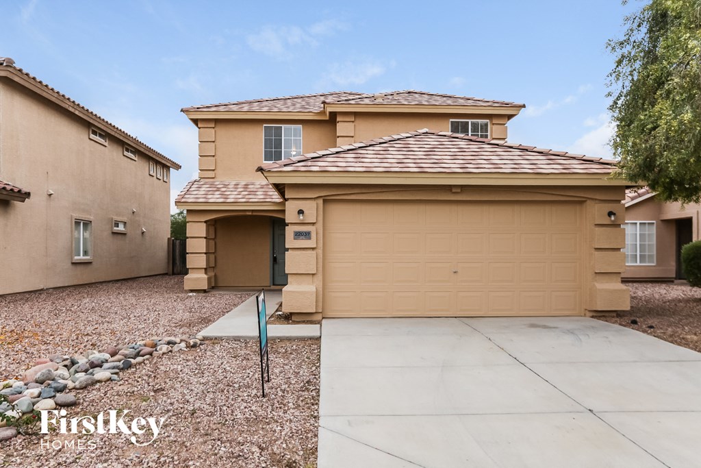 a house with a garage door and a driveway