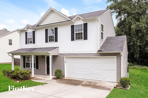 A two-story house with a garage is for sale.