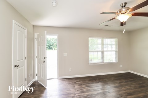 A room with a ceiling fan and a window.