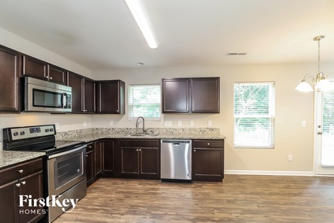 A kitchen with brown cabinets and a stainless steel dishwasher.