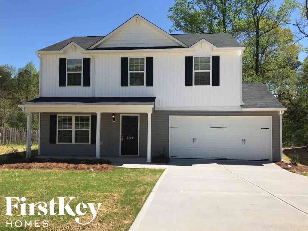 A two-story house with a garage is for sale.