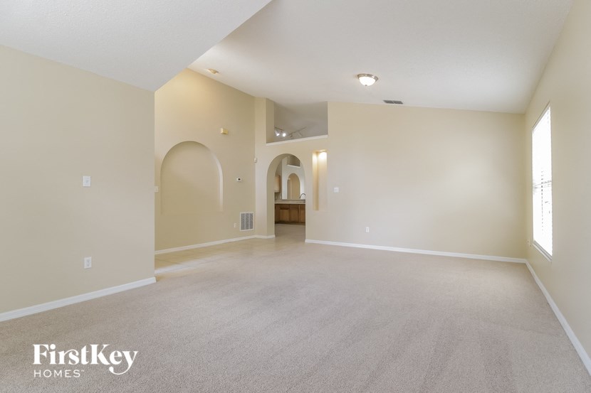 the spacious living room and dining room in a new home
