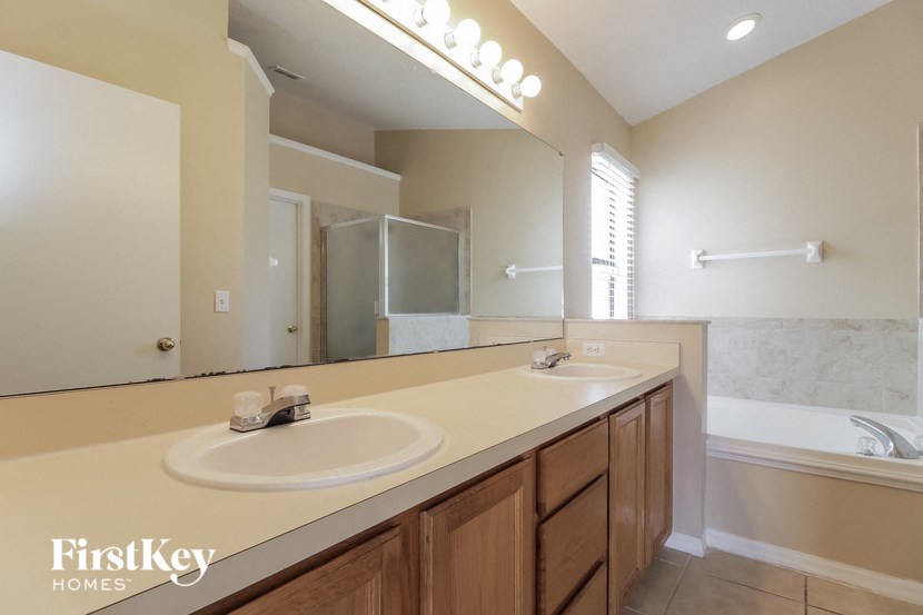 a bathroom with two sinks and a large mirror