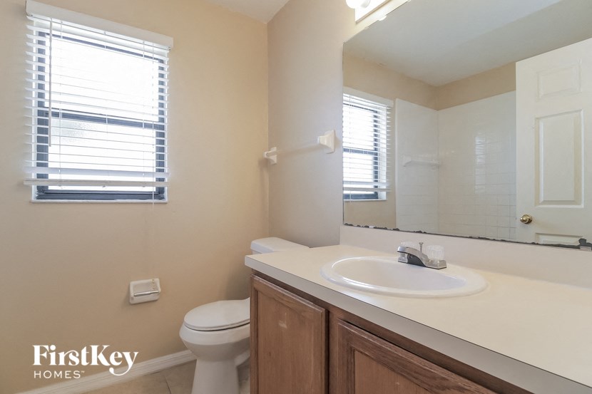 a bathroom with a sink toilet and a mirror
