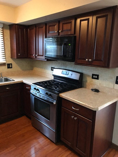 a kitchen with a stove and a microwave