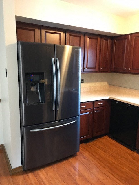 a kitchen with a stainless steel refrigerator