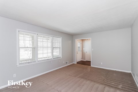 a living room with a hard wood floor and a large window