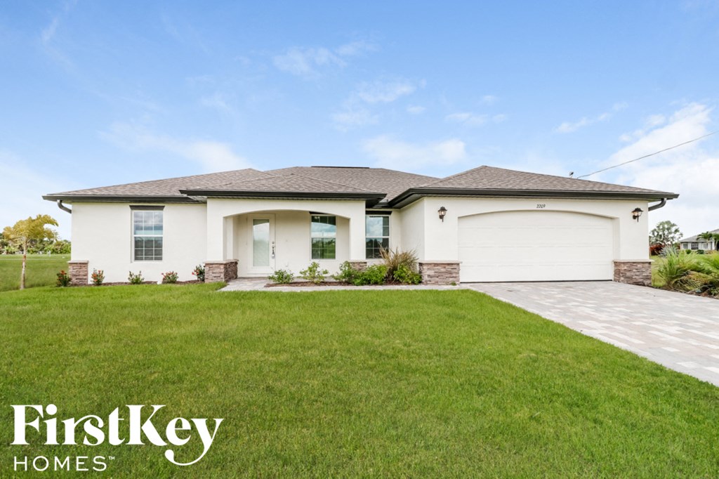 A house with a white garage door and a brown roof.