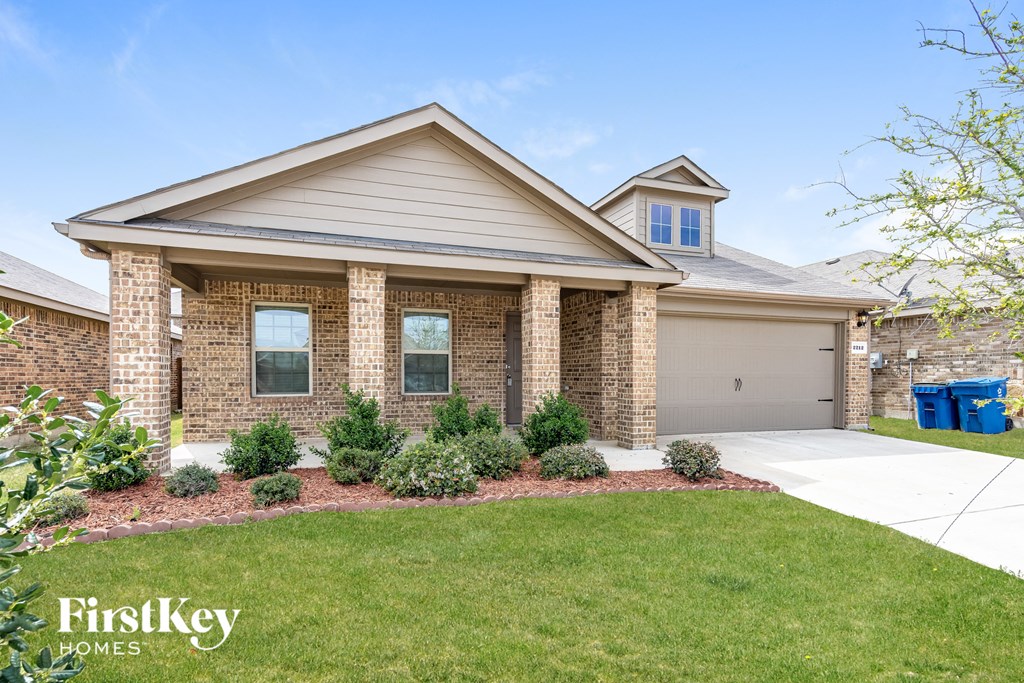 a home with a lawn and a driveway
