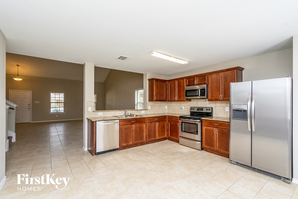a kitchen with stainless steel appliances and wooden cabinets
