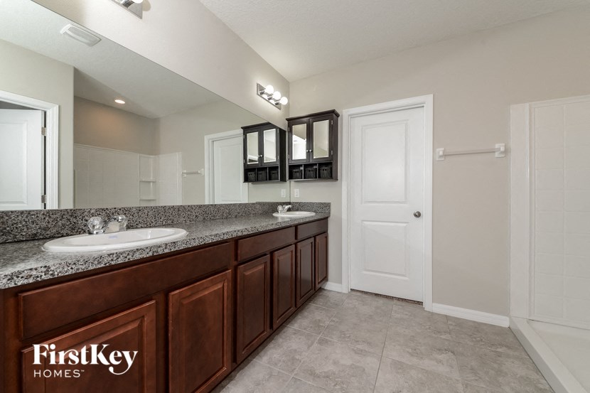 a bathroom with two sinks and a mirror