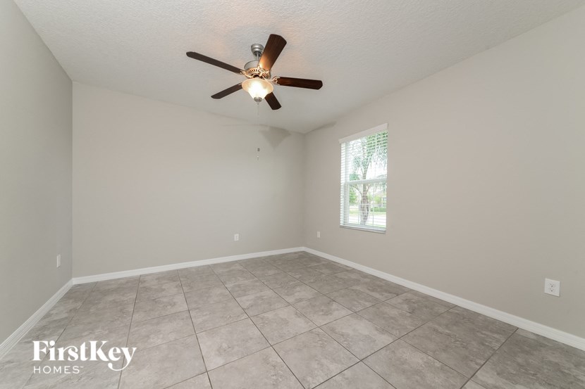 a empty living room with a ceiling fan