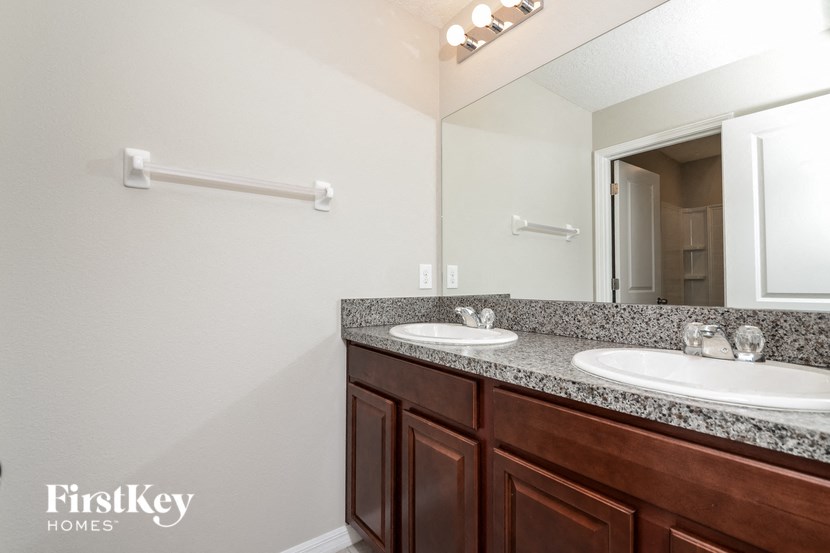 a bathroom with two sinks and a mirror