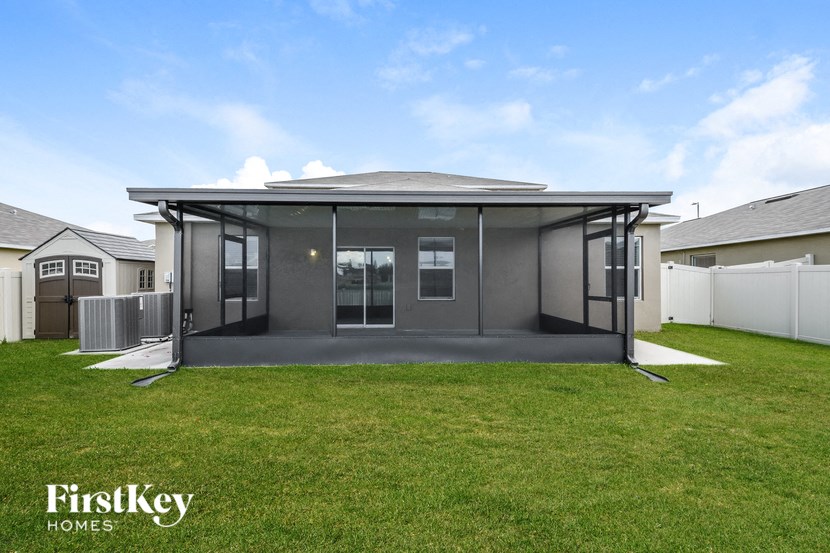 a modern house with a lawn and a fence