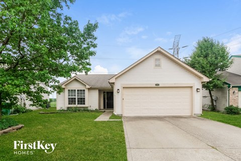 a white house with a driveway and a white garage door