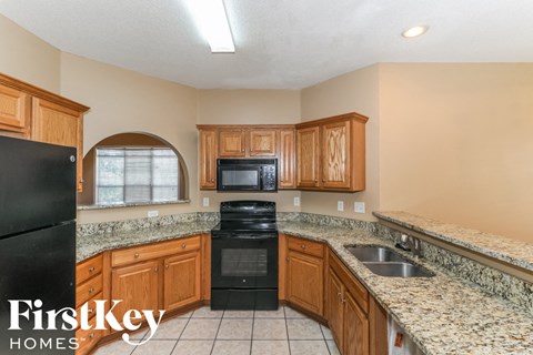 a kitchen with granite counter tops and a black appliances