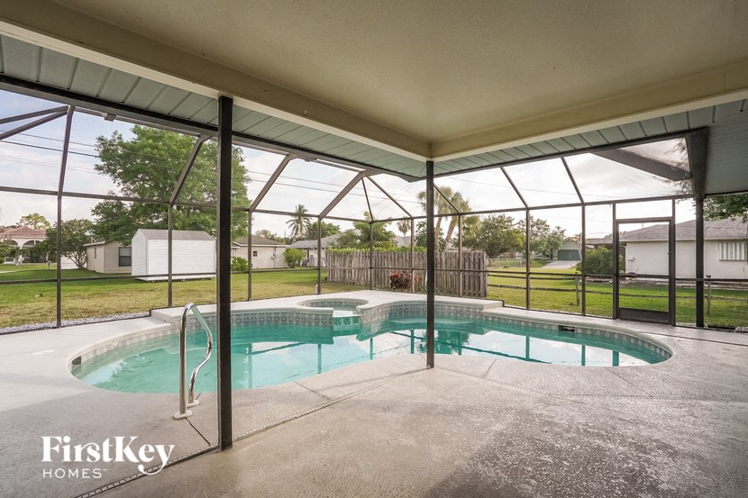 A pool inside a house with FirstKey Homes written on the bottom left.