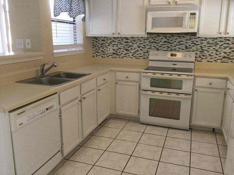 A white kitchen with a microwave above the stove.