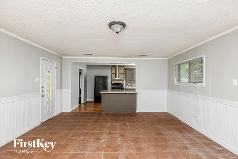 a dining room and kitchen with a counter and a sink