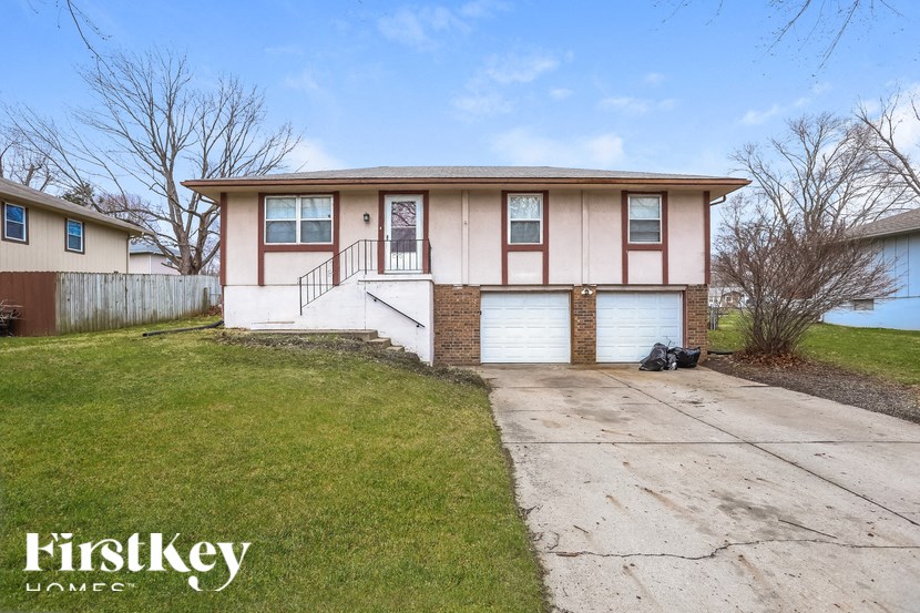 A two-story house with a garage is for sale.