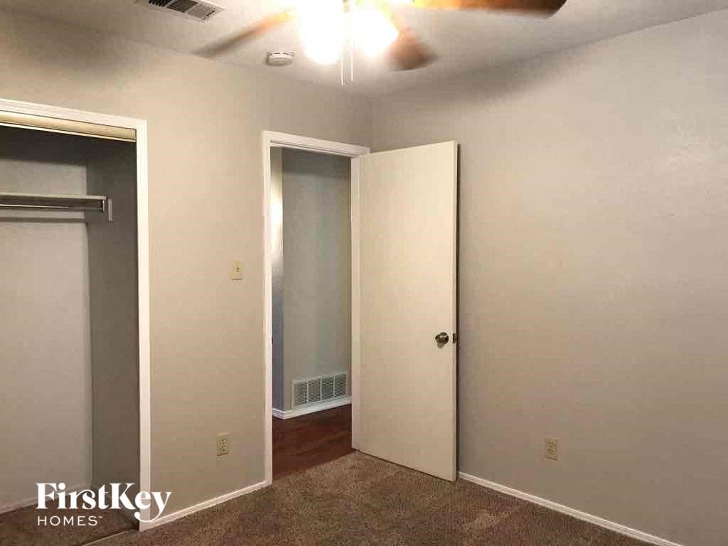 an empty room with a closet and a door to a closet