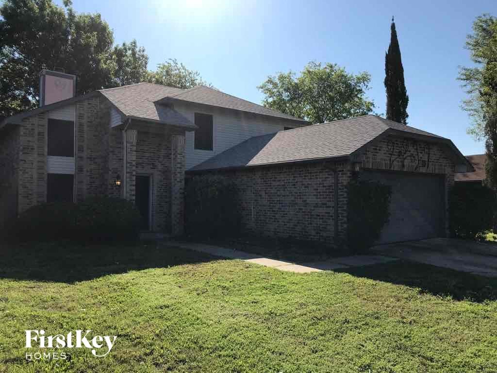 front view of a brick house with a lawn