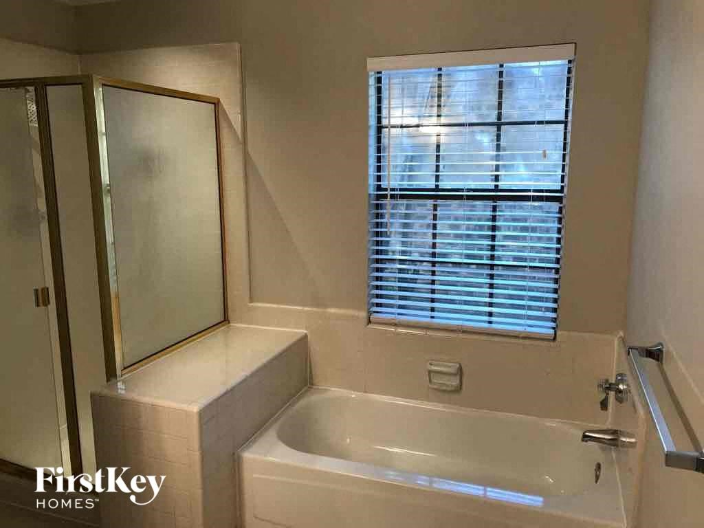 a bathroom with a bath tub and a window