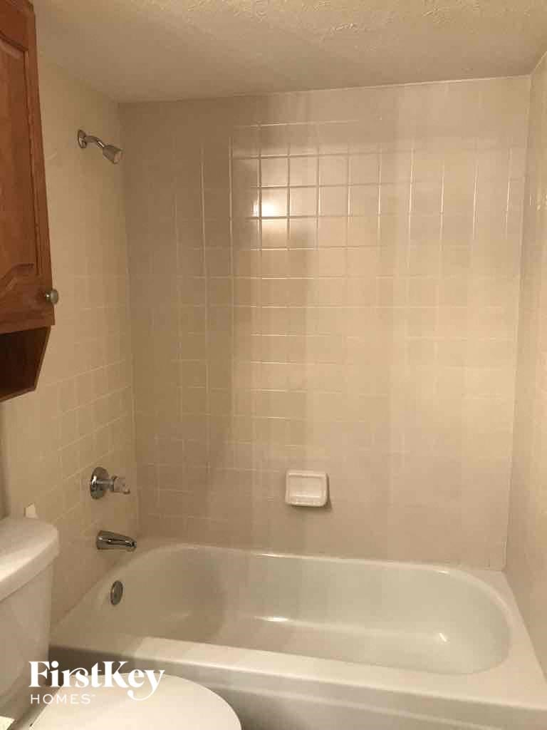 a bathroom with a tub and a toilet and a sink