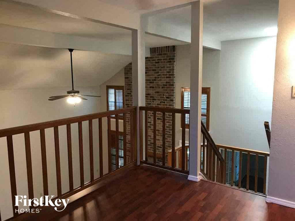 a view from the top of a staircase in a home with a wood floor