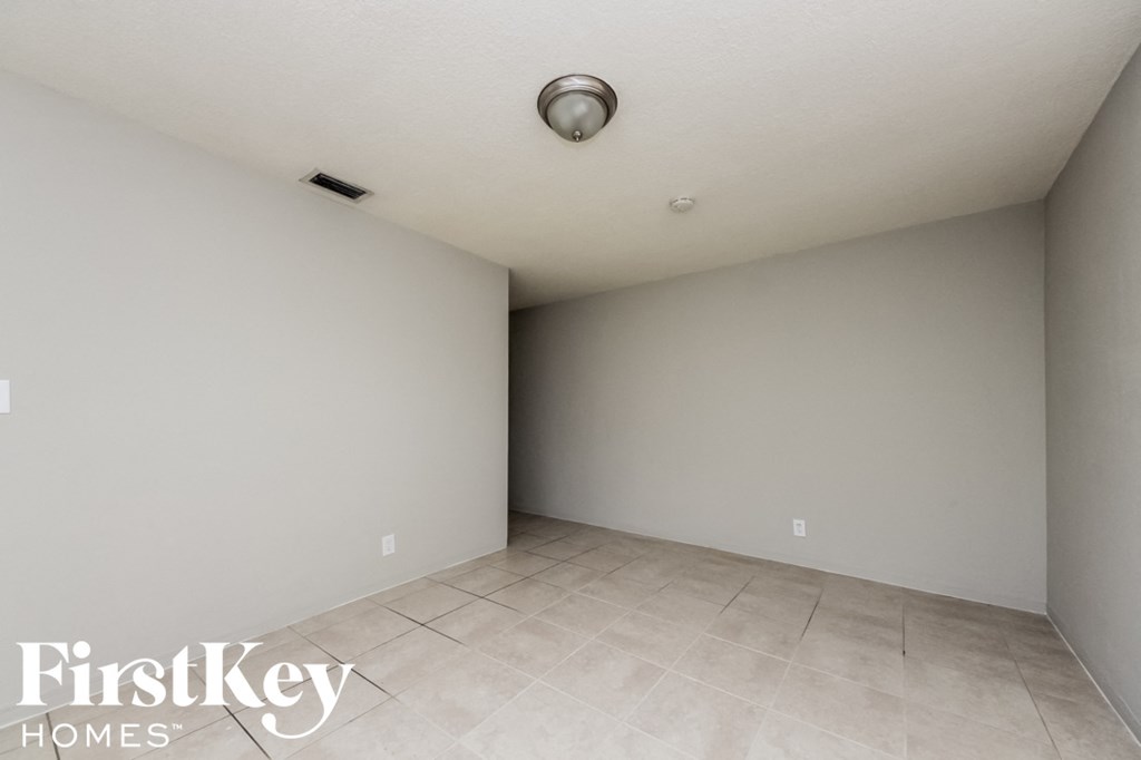 a empty room with a tile floor and white walls