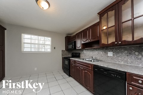a kitchen with wooden cabinets and a sink and a dishwasher