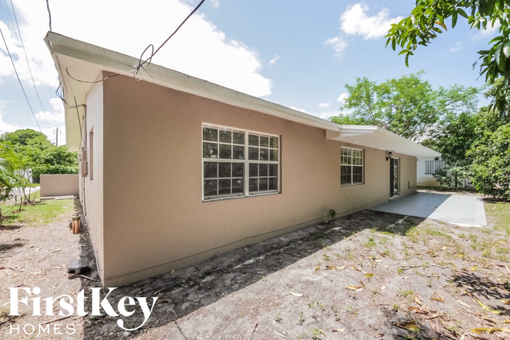 the front of a house with a driveway and a garage door