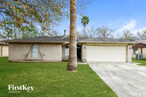 A house with a tree in front of it.