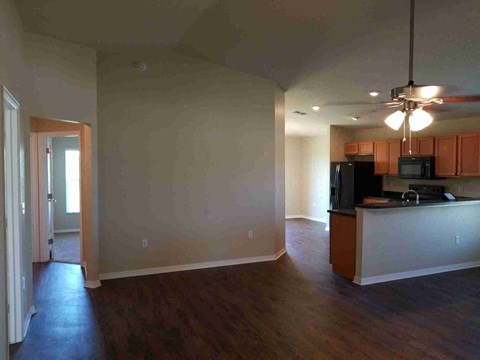 A kitchen area with a counter and a microwave.