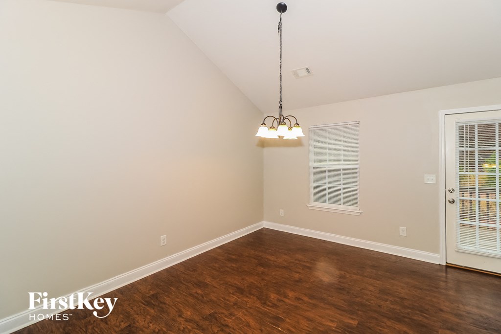a bedroom with a hard wood floor and a chandelier