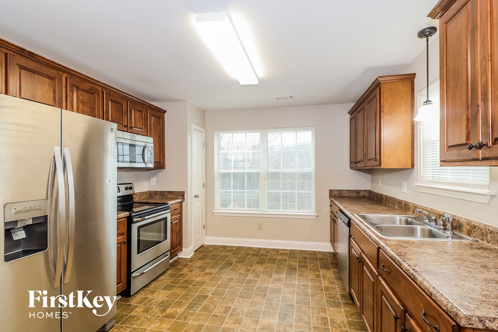 a kitchen with wooden cabinets and stainless steel appliances