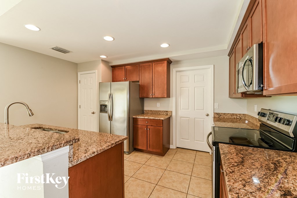 a kitchen with granite counter tops and stainless steel appliances
