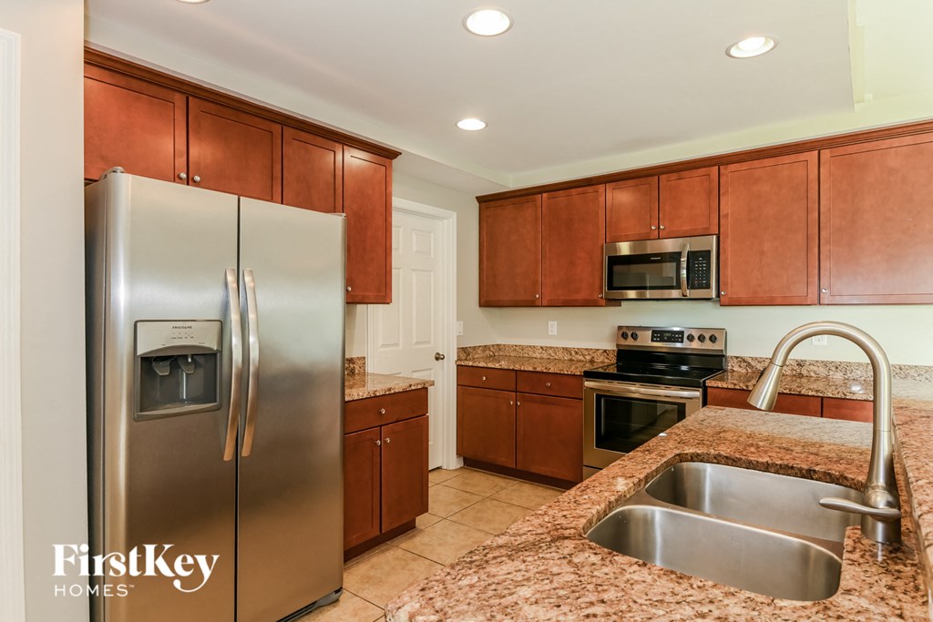 a kitchen with stainless steel appliances and granite counter tops