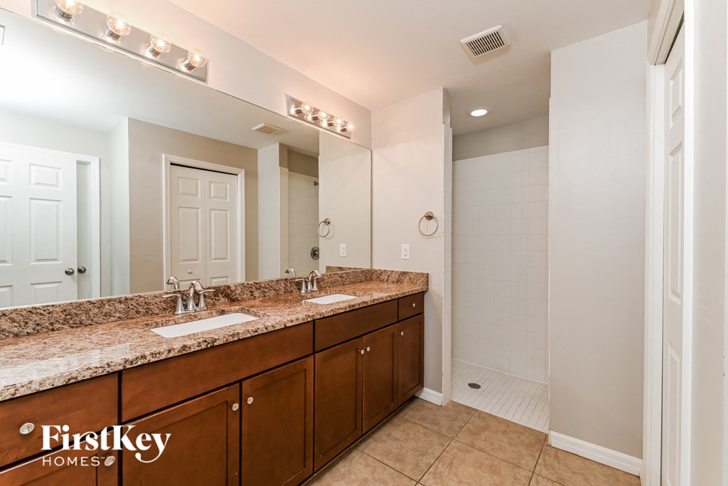 a bathroom with two sinks and a large mirror