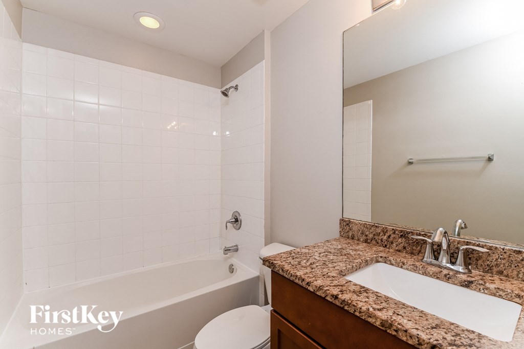 a bathroom with a sink and a tub and a toilet