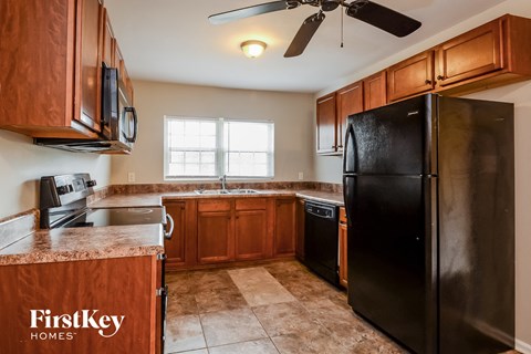 a kitchen with black appliances and wooden cabinets