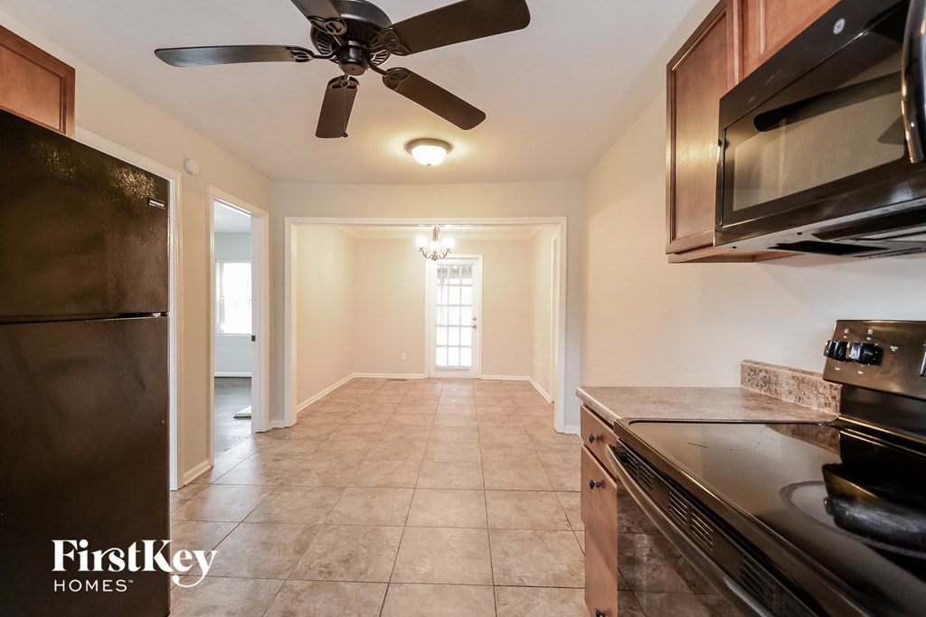a kitchen with stainless steel appliances and a ceiling fan