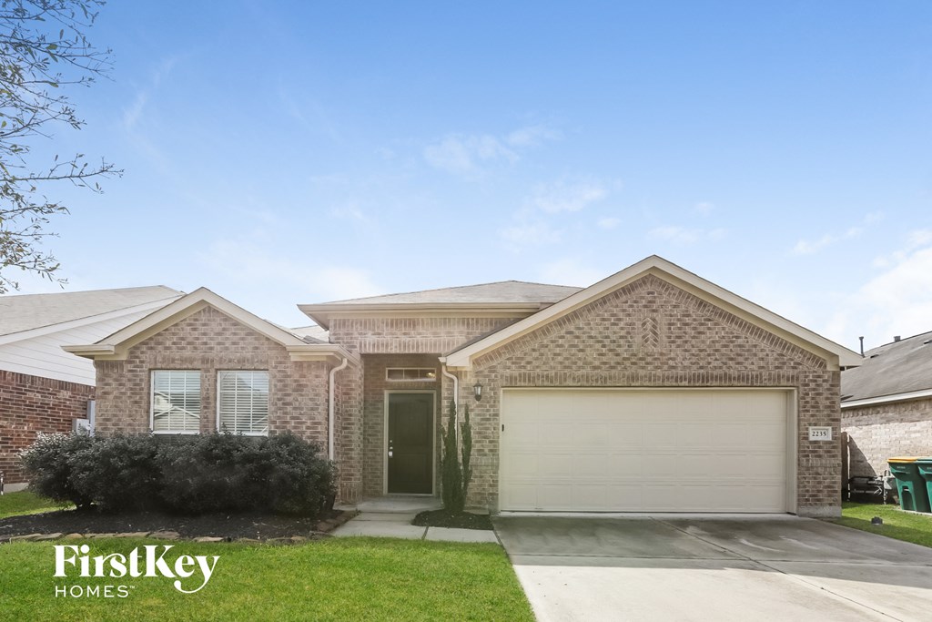 a house with a garage door and a lawn