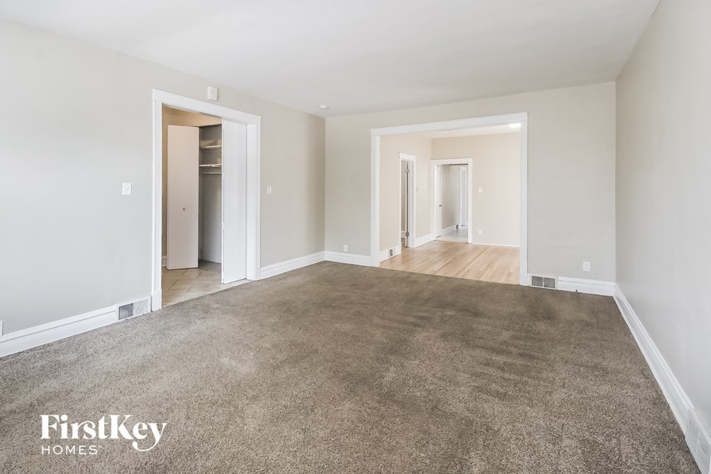 a living room with a carpeted floor and white walls