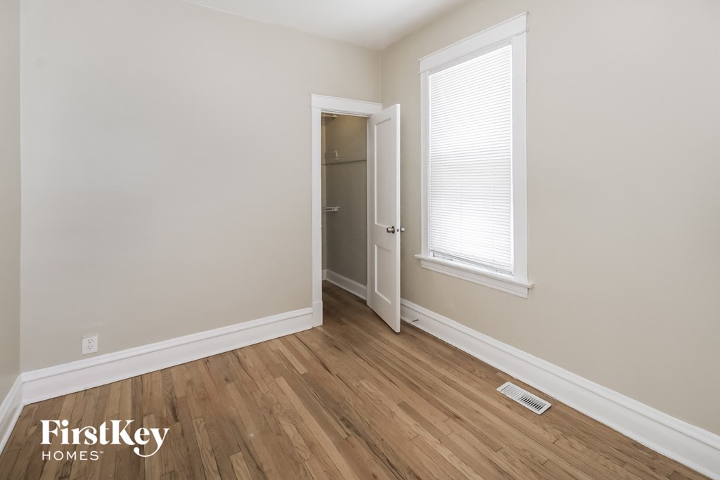 the living room with hardwood flooring and a door to the closet