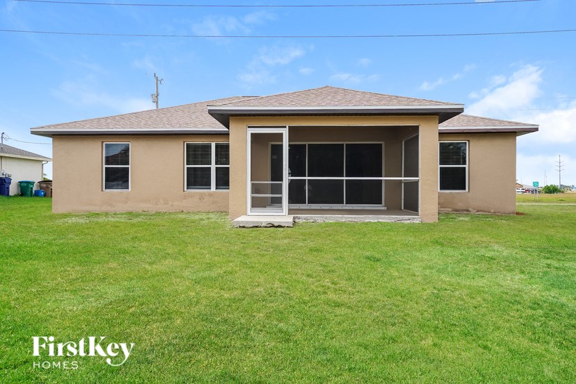 A house with a brown roof and a beige exterior is for sale.